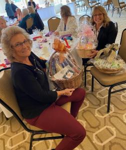 Member, Salinda Weary (right) and her guest, Tina Bollinger (left) won several of the auction baskets.
